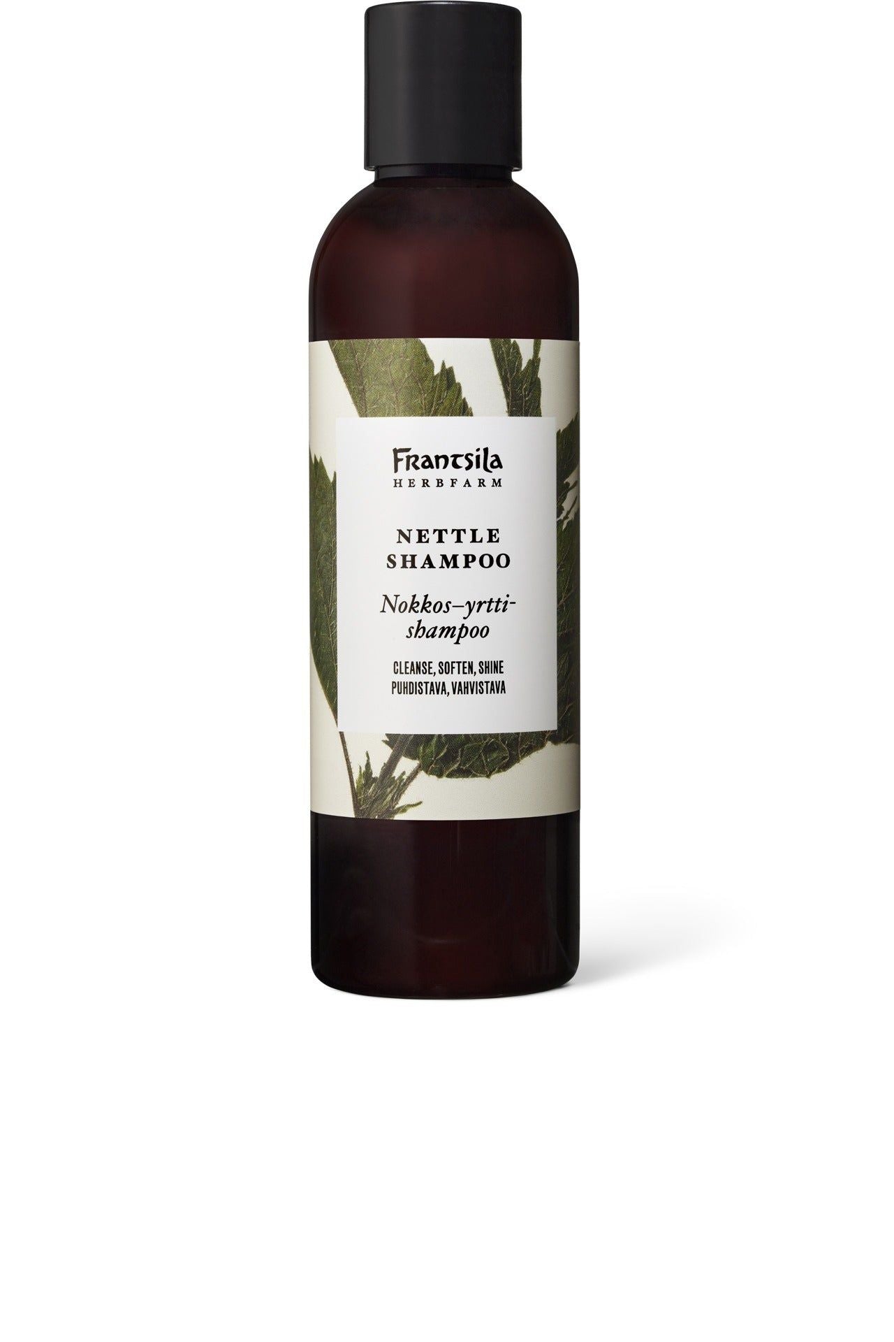 A brown bottle of Frantsila Herb Farm Nettle Shampoo with a white label featuring vibrant green nettle leaves and product information in both English and Finnish. The bottle has a cylindrical shape with a black cap, glossy finish, and printed text in clear, sans-serif fonts. The photo is taken against a plain white background with no people or additional objects present.