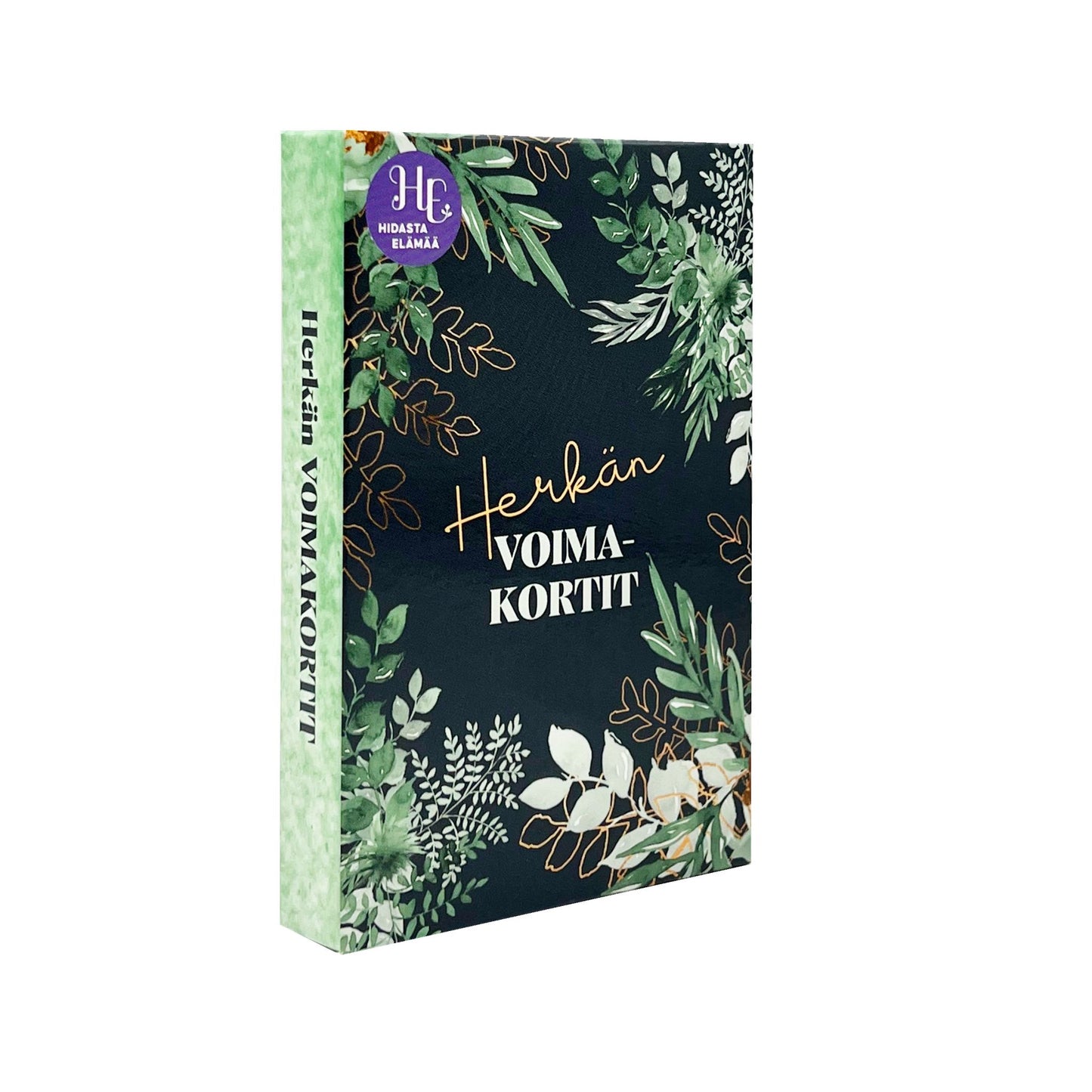 A dark green box with botanical leaf designs and gold text reading Herkkän VOIMAKORTIT. The box features a purple logo in the top left corner and a light green spine with the product name. Rectangular shape, likely cardboard material, matte finish. Serif gold lettering on front. No people or hands visible. The background is plain white, shown in a straightforward product shot.