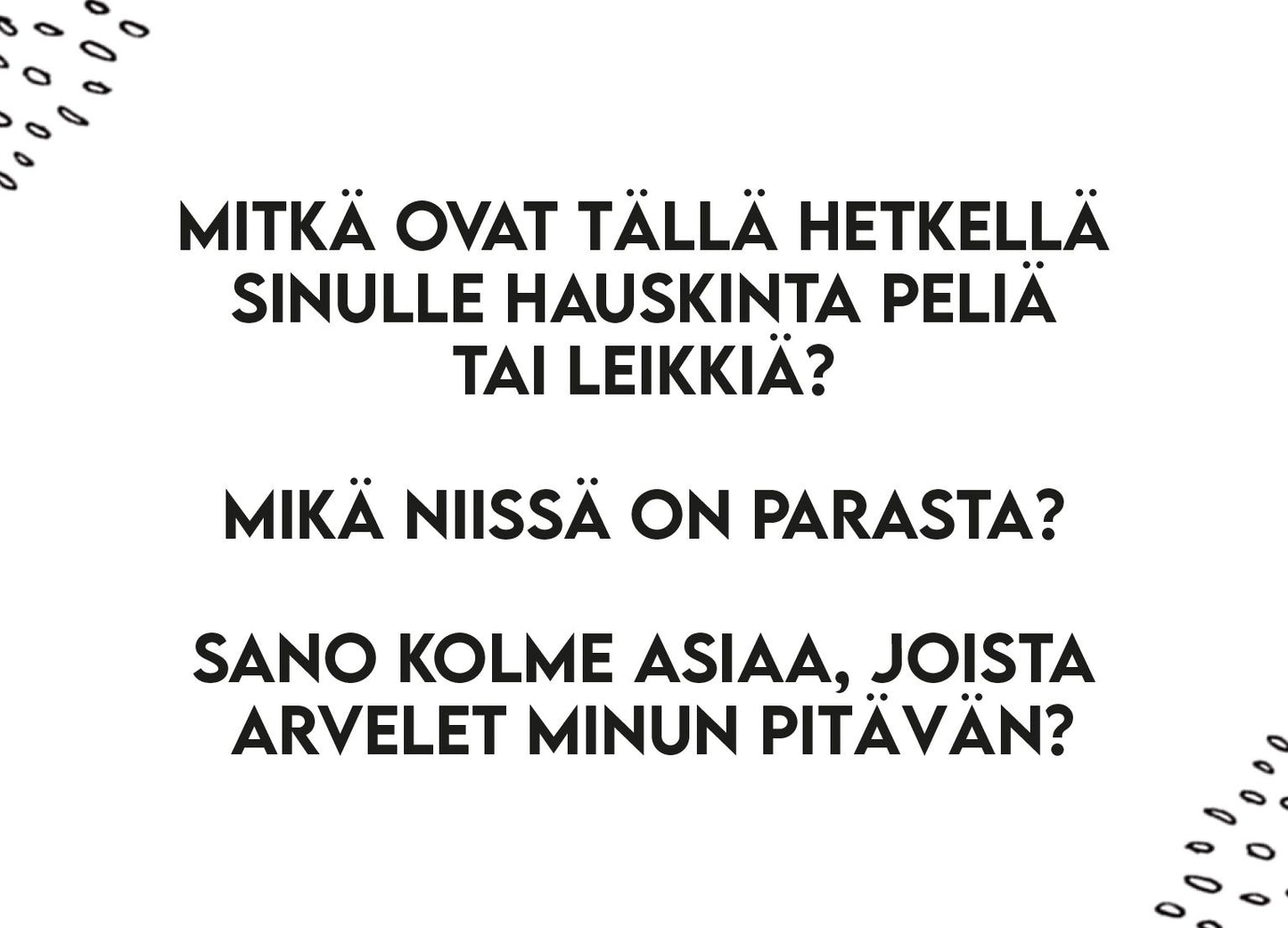 Printed sheet with Finnish text on a smooth white background. Black doodle designs are in each corner, playful and hand-drawn in style. Three questions are shown in a clear, sans-serif font: about fun games, what makes them enjoyable, and three things the reader thinks the writer likes. No visible packaging or branding. Flat lay shot with no people or hands present.