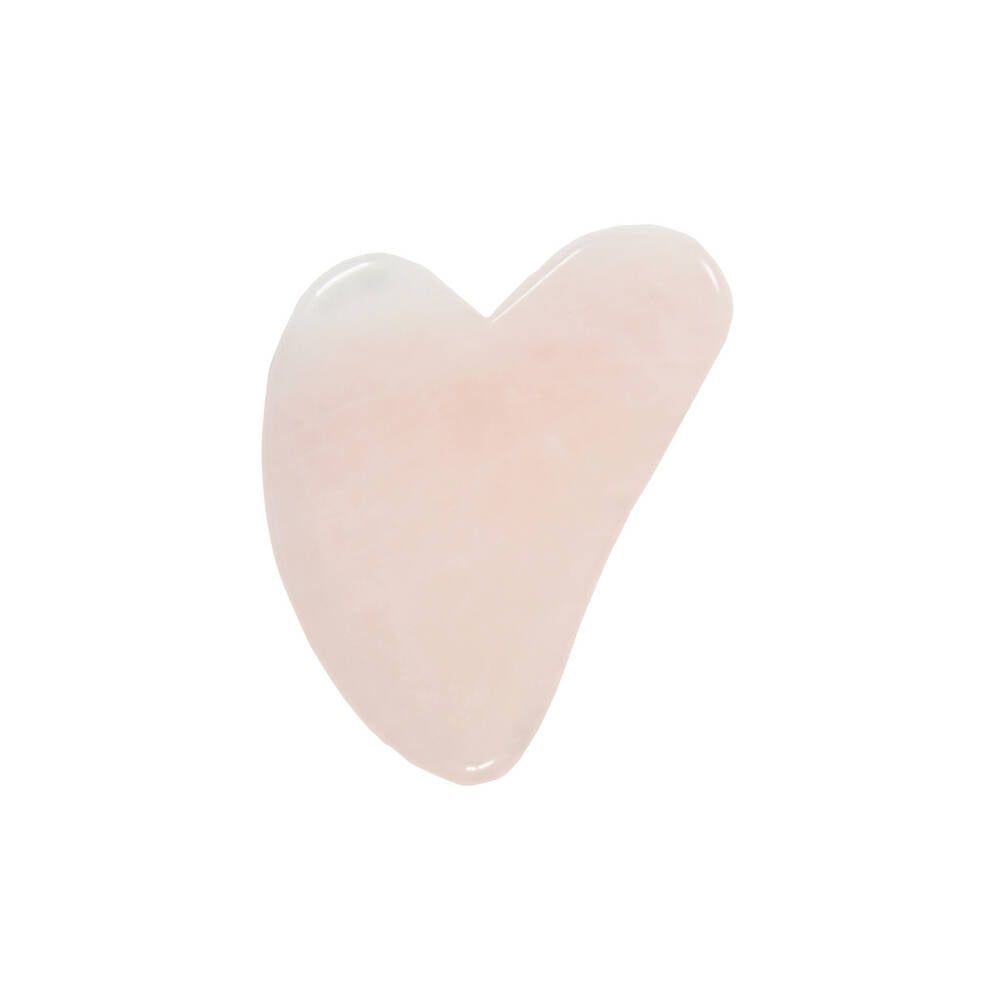A smooth, rose quartz heart-shaped stone tool is positioned on a plain white background. The tool is light pink, semi-translucent, with a polished glossy surface and no visible markings or labels. There is no packaging, text, or human presence shown in the image.