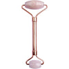 A rose quartz facial roller with a metal handle features two cylindrical rollers, one larger and one smaller, mounted on either end of the handle. The metal handle appears glossy silver, and both rollers are light pink with a smooth finish. No packaging or labeling is visible. The background is plain white with even lighting. A rose quartz facial roller with a metal handle features two rollers—one large and one small—on each end, ideal for skincare routines and facial massage.