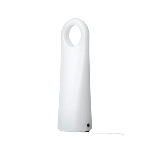 A tall, modern white lamp with a rounded top featuring a circular cutout and a small black button near the base, illuminated against a plain light background. Lamp has a smooth matte finish. No visible packaging or label text. Cylindrical body tapers slightly toward the bottom. Plain background, no people or actions present. The shot is centered and tightly cropped around the lamp.
