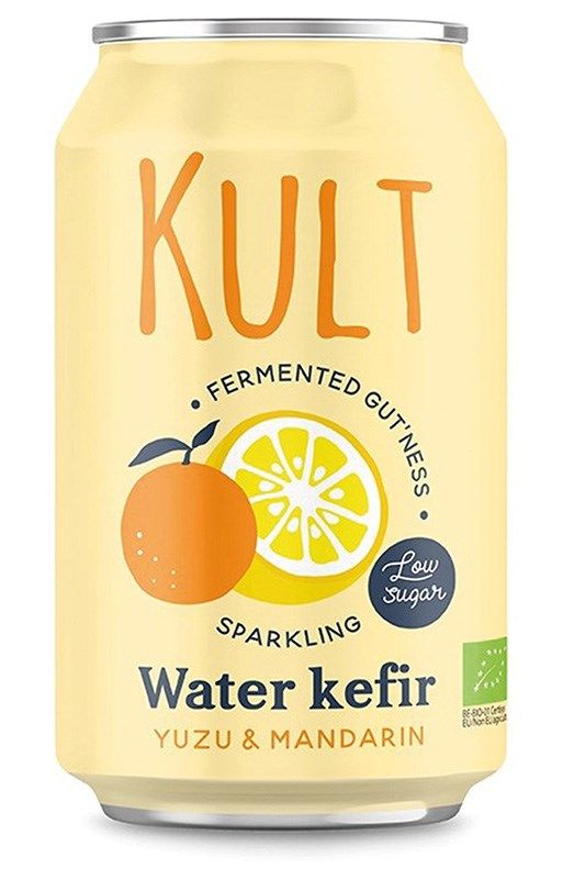 A yellow can of Kult Water Kefir Yuzu & Mandarin, featuring images of an orange and a lemon, with text highlighting low sugar, fermented goodness, and sparkling probiotics. Cylindrical metal can with a matte finish. Main text in bold sans-serif font; accent fonts used for flavor and health claims. Plain studio background, no people or actions visible. Front-facing product shot showing the entire label.