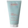 Laboratoires de Biarritz After-Sun Fluid: vaaleansininen tuubi tekstillä "Laboratoires de Biarritz After-Sun Fluid" oranssilla ja valkoisella tekstillä, kosteuttavia ja rauhoittavia ominaisuuksia; tuubi on 150 ml, muovia, mattapinnalla ja valkoisella läppäkorkilla; etuosan teksti korostaa 99,5 % luonnollisia ainesosia; tuote seisoo pystyssä valkoista taustaa vasten studiokuvassa.