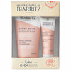 Boxed set of Biarritz France hand cream (50ml) and lip balm (15ml) with pink and white packaging, labeled for damaged, irritated, very dry hands and lips. Both items displayed inside a rectangular box with a matte finish. Notable legible text states product type and intended use. Special offer sticker on lower right—a thoughtful gift from Biarritz France for nourishing everyday essentials. Plain background; no people or hands visible in the image. Shot is a straightforward product-only photo taken from
