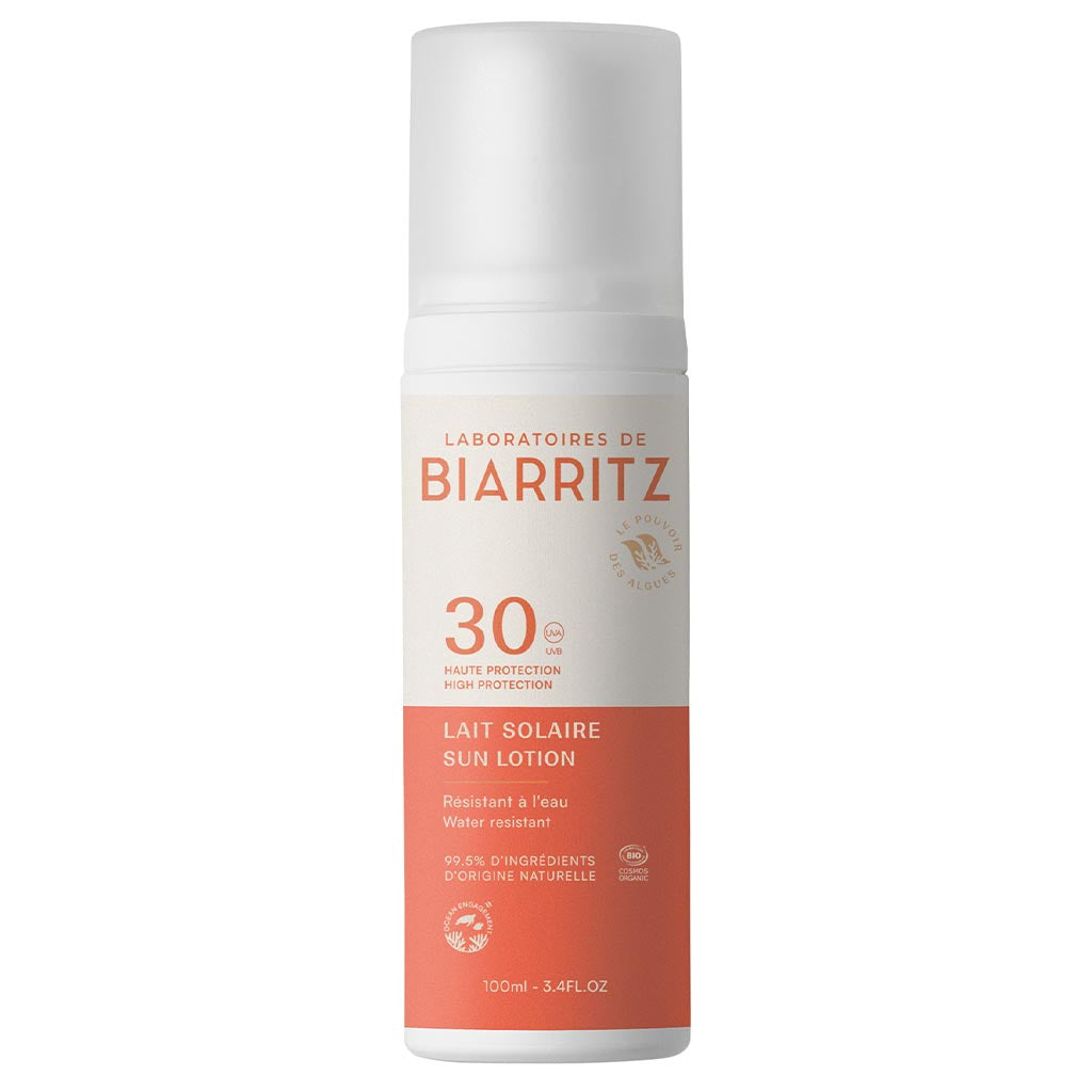 Bottle of Laboratoires de Biarritz SPF 30 sun lotion, 100ml, with a white top and orange label, offering high protection and water resistance, made with 99.5% natural ingredients for gentle yet effective care. The bottle is cylindrical with a matte finish and features clear sans-serif typography for brand and product details on the front label. The image shows only the single bottle against a plain white background in a product-only shot. No people or hands are present.
