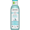 A bottle of Lavera Basis Sensitiv Body Wash 2in1, labeled for body and hair, featuring organic aloe vera and plant keratin. The packaging is mainly light blue and white in color with a matte finish. Vegan and climate-neutral certification icons are present on the front. Text is printed in sans-serif typeface, with product claims in bold. The background is plain white, no people or props are visible.