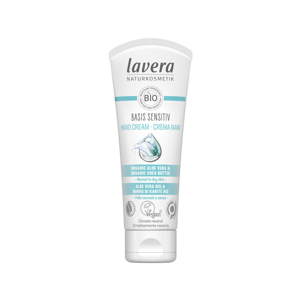 A tube of Lavera Basis Sensitiv Hand Cream, featuring organic aloe vera and shea butter. The white, matte-finish plastic tube is upright with a rounded flip cap. Label text in English and Italian covers the front, with several certification logos. Sans-serif font is used for product details. The background is plain and evenly lit with no people or props visible.