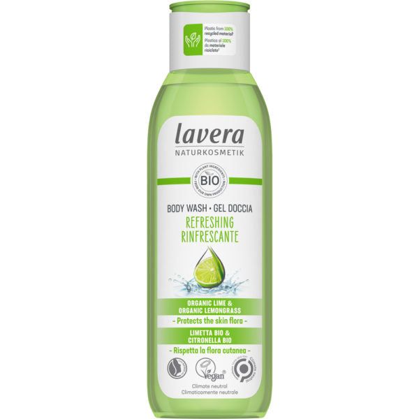A bottle of Lavera Naturkosmetik body wash, labeled Refreshing, with organic lime and lemongrass, suitable for vegans and enriched with natural ingredients, in a green and clear container. Plastic cylindrical bottle with clear lower half and opaque green flip-cap. Front label has sans-serif white text on a green background; main product details are legible. Plain white background; no people or props visible.