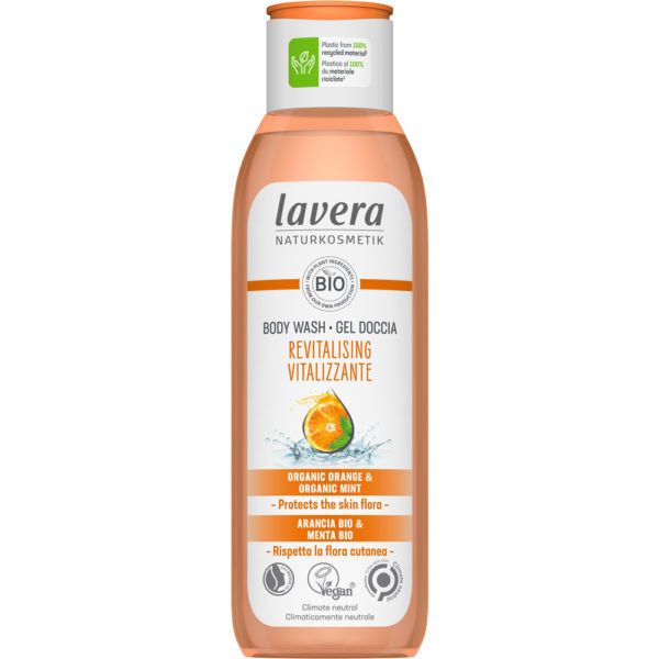 A bottle of Lavera Naturkosmetik Revitalising Body Wash with organic orange and mint. The plastic bottle has a white body, a green flip-top cap, and a semi-gloss finish. The front label shows an orange slice and mint leaves image. Text on the label notes “protects skin flora,” “vegan,” and “climate-neutral.” No people or hands are visible. The background is plain white.