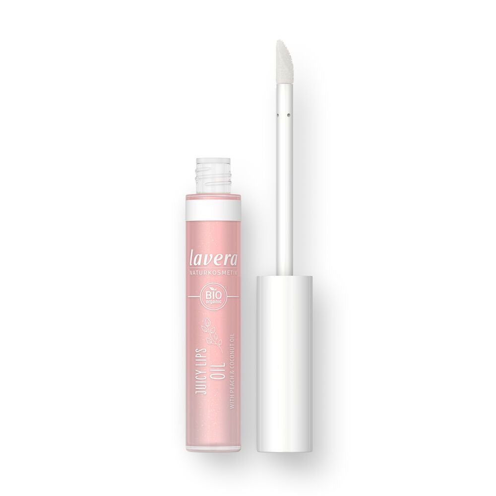 A pink cylindrical tube of Lavera Juicy Lips Oil is shown with its cap removed to display a white applicator wand. The packaging has a glossy finish with white sans-serif text and floral illustrations on the label. Visible label text mentions its nourishing formula. The background is plain and uncluttered. No people or hands are present in the shot.