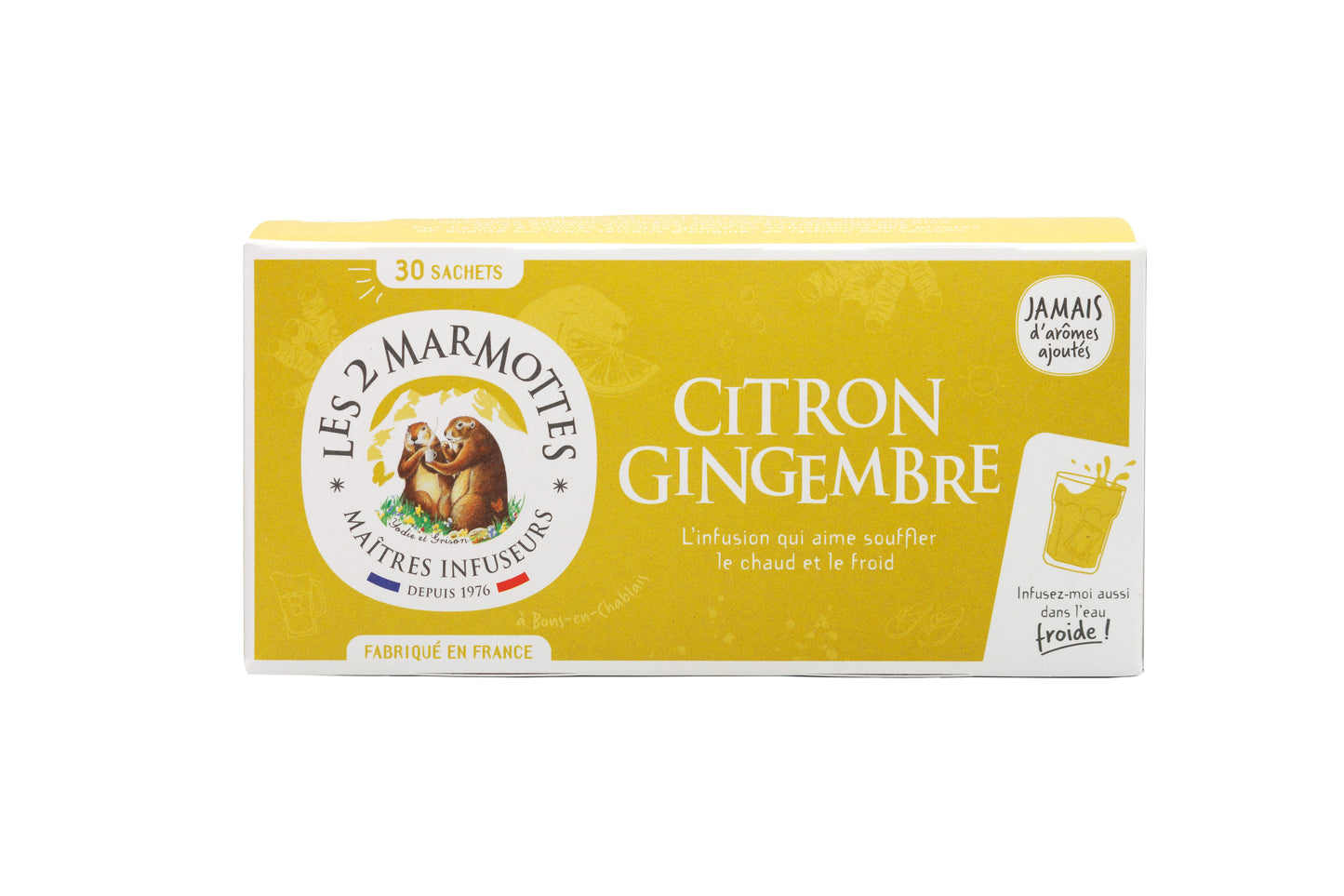 Rasia Les 2 Marmottes Citron Gingembre -yrttiteetä, väreinä keltainen ja valkoinen, kuvituksena kaksi murmelia sekä ranskankielinen teksti sitruuna-inkiväärimausta. Rasia on suorakulmainen mattapinnalla. Pääetiketissä käytetään lihavoitua pääteviivatonta typografiaa mustalla ja tummankeltaisella. Ihmisiä tai käsiä ei näy. Tausta on valkoinen tasaisessa valaistuksessa, kuva otettu silmän korkeudelta.