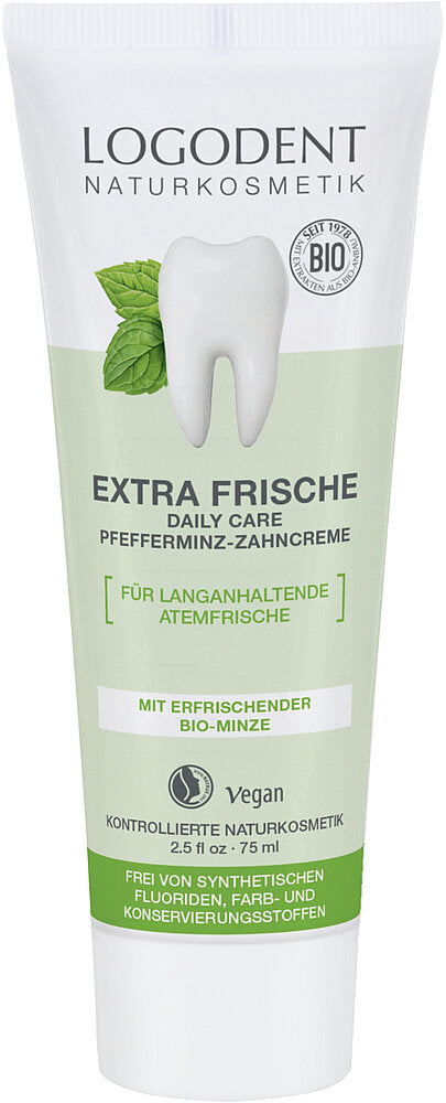 A tube of Logodent Naturkosmetik Extra Frische peppermint toothpaste with a tooth and mint leaves on the label. The tube is upright, made of glossy white and light blue plastic with dark blue, green, and white accents. Packaging is rectangular with a matte finish. Sans-serif font is used for the product name and details. Key label text notes its vegan, organic, synthetic-free ingredients. Plain white background; no people or additional objects are present in this studio shot.
