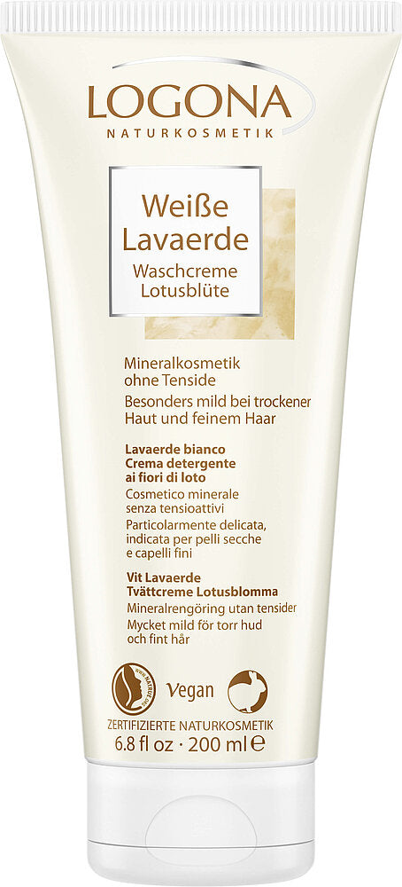 Tube of LOGONA Weiße Lavaerde Waschcreme Lotusblüte. The tube is white with muted pink and grey graphics, matte finish, and rounded edges. The front label contains clear typography in a mix of uppercase and lowercase. Product volume is indicated as 200 ml. No people or hands visible; shot has a plain background with even lighting. Text highlights it as a mineral-based, vegan cleansing cream with gentle lotus blossom for dry skin and fine hair, free of sulfates, with multilingual product details and a 200ml