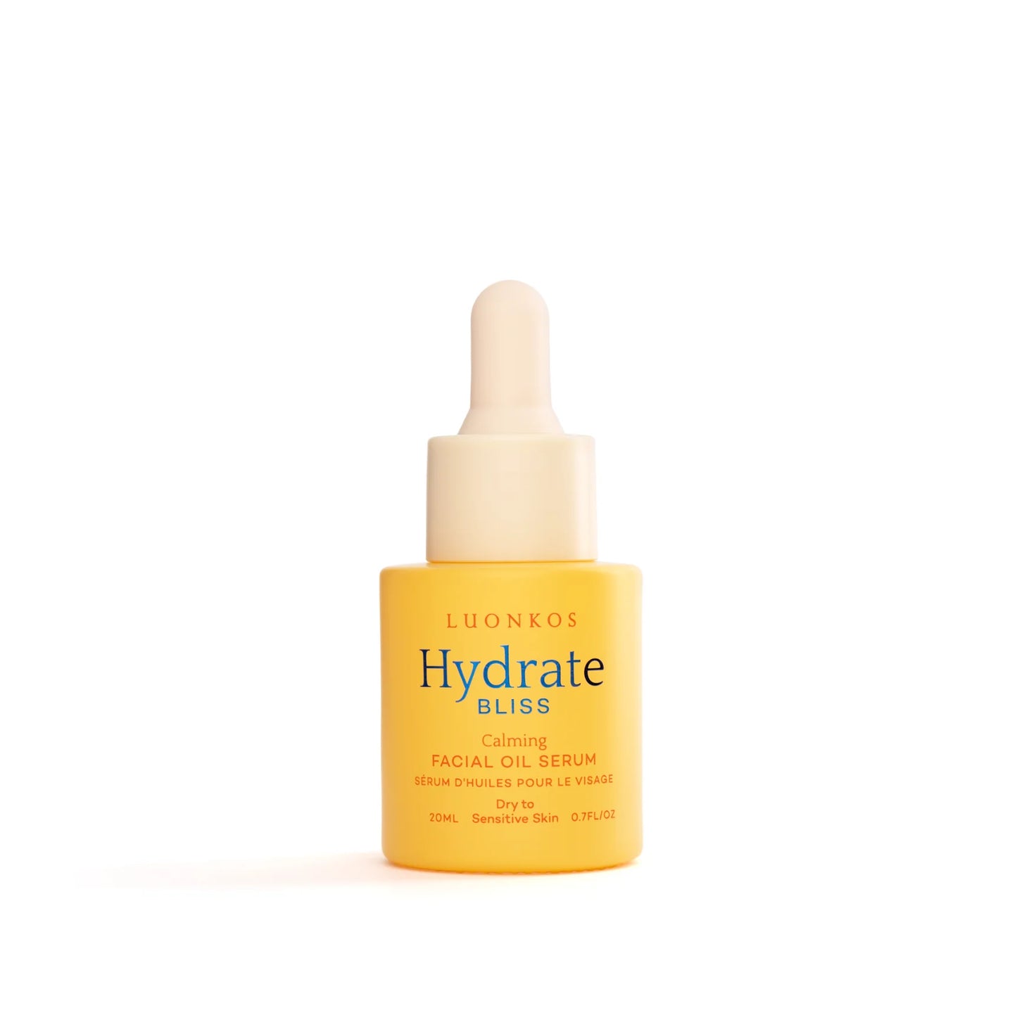 Keltainen Luonkos Hydrate Bliss Calming Facial Oil Serum -pullo valkoisella pipettikorkilla on kuvan keskellä; pullo sileäpintainen mattamuovi ja lieriömäinen; etiketissä minimalistista mustaa groteskitekstiä tuotenimelle; kuvan tausta valkoinen, ei ihmisiä tai muita esineitä näkyvissä.