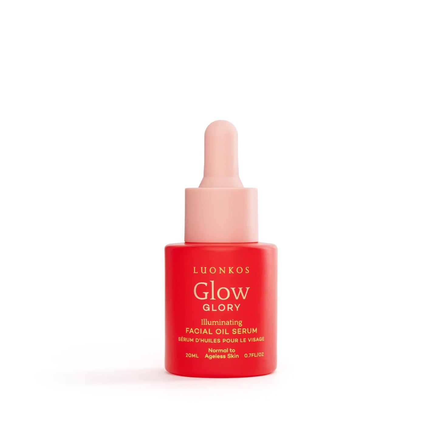 Pieni punainen Luonkos Glow Glory Illuminating Facial Oil Serum -pullo vaaleanpunaisella pipettikorkilla seisoo pystyssä valkoisella taustalla; pullo lieriömäinen mattapinnalla; etiketissä yksinkertaista groteskikirjasinta tuotenimelle; ei ihmisiä tai käsiä näkyvissä tässä studiokuvassa.