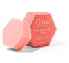 Luonkos Glow Devotion Hand & Body Soap; vaaleanpunainen kuusikulmainen saippuapala nojaa yhteensopivaa kuusikulmaista rasiaansa vasten, jossa teksti ”Glow Devotion Hand & Body Soap: Cleansing, Apricot Kernel Oil, Luonkos”, suunniteltu normaalille ja kypsälle iholle; sekä saippua että rasia mattapintaisia; rasian typografia lihavoitua tikkukirjasinta; kuvausympäristö tasainen valkoinen, ei ihmisiä tai muita esineitä näkyvissä.