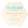 Luonkos Hydrate Essence Hand & Body Soap; kuusikulmainen saippuapakkaus tekstillä ”Hydrate Essence Hand & Body Soap, Cleansing, Dry to Sensitive Skin, No Added Scents, LUONKOS”, kosteuttavaa sinistä ja oranssia tekstiä kermanvärisellä taustalla; rasia mattapintainen ja terävärajainen; typografia selkeää tikkukirjasinta; kuva näyttää tuotteen tasaisella valkoisella tai vaalealla taustalla ilman ihmisiä tai rekvisiittaa.