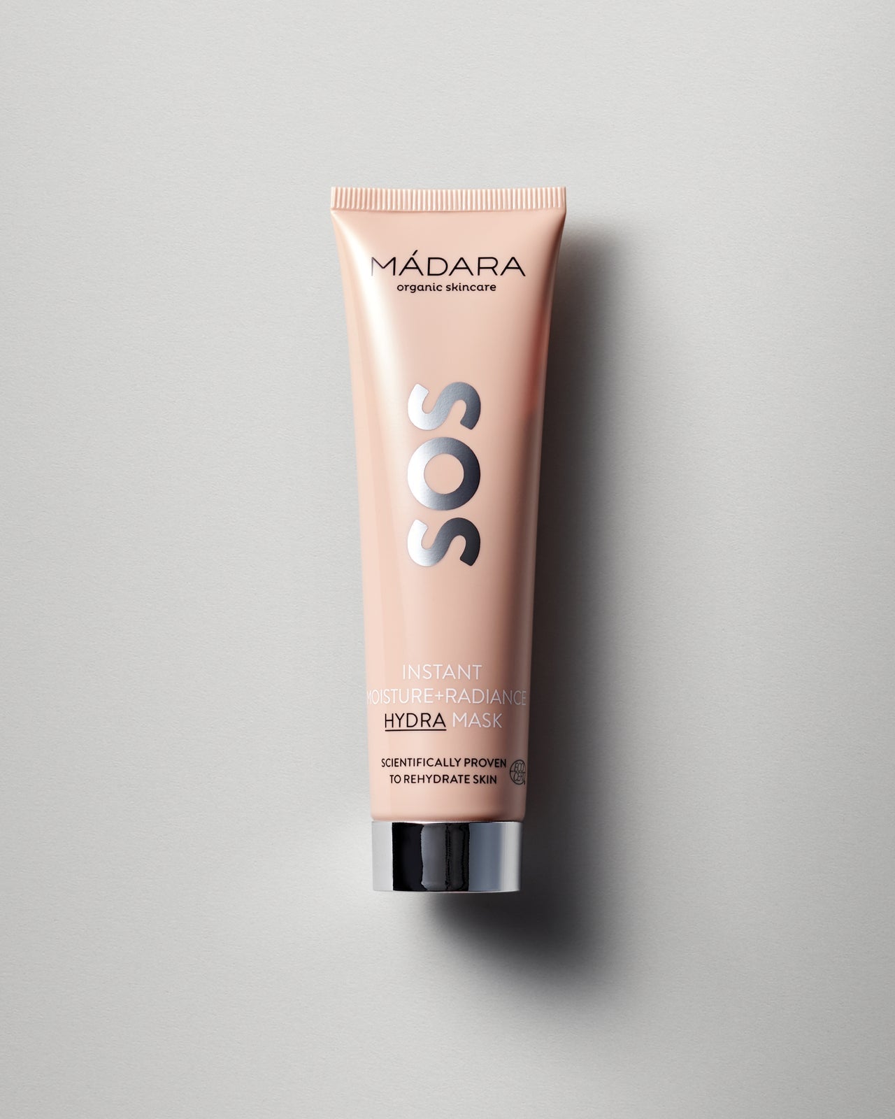 Madara SOS Hydra Mask naamio persikanvärisessä tuubissa harmaalla taustalla