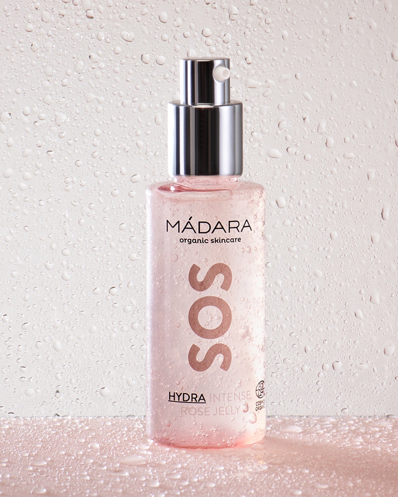 Madara SOS Rose Jelly -pullo kirkkaiden geelipisaroiden keskellä
