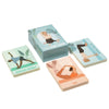 A rectangular box labeled “Yoga Pose Cards” sits on a matte white surface, with several illustrated cards partially fanned out in front. The cards show named yoga poses: Revolved Triangle, Bow, and Three-Legged Dog. The label uses clear sans-serif type. No people or hands are visible in the image. A box labeled Yoga Pose Cards with illustrated cards showing yoga poses such as Revolved Triangle, Bow, and Three-Legged Dog, all neatly arranged on a white surface—perfect for enhancing your mindfulness practice.