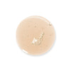 A close-up of a transparent, hydrating light beige liquid gel droplet with small air bubbles inside, isolated on a white background. Product type: liquid gel. Color: light beige. Material: gel consistency. Surface finish: glossy, reflective. Shape: irregular rounded droplet with visible smaller bubble shapes inside the main mass. No packaging or labels present in image. Background is solid white; no typography, people, or actions shown. Shot type is close-up detail.