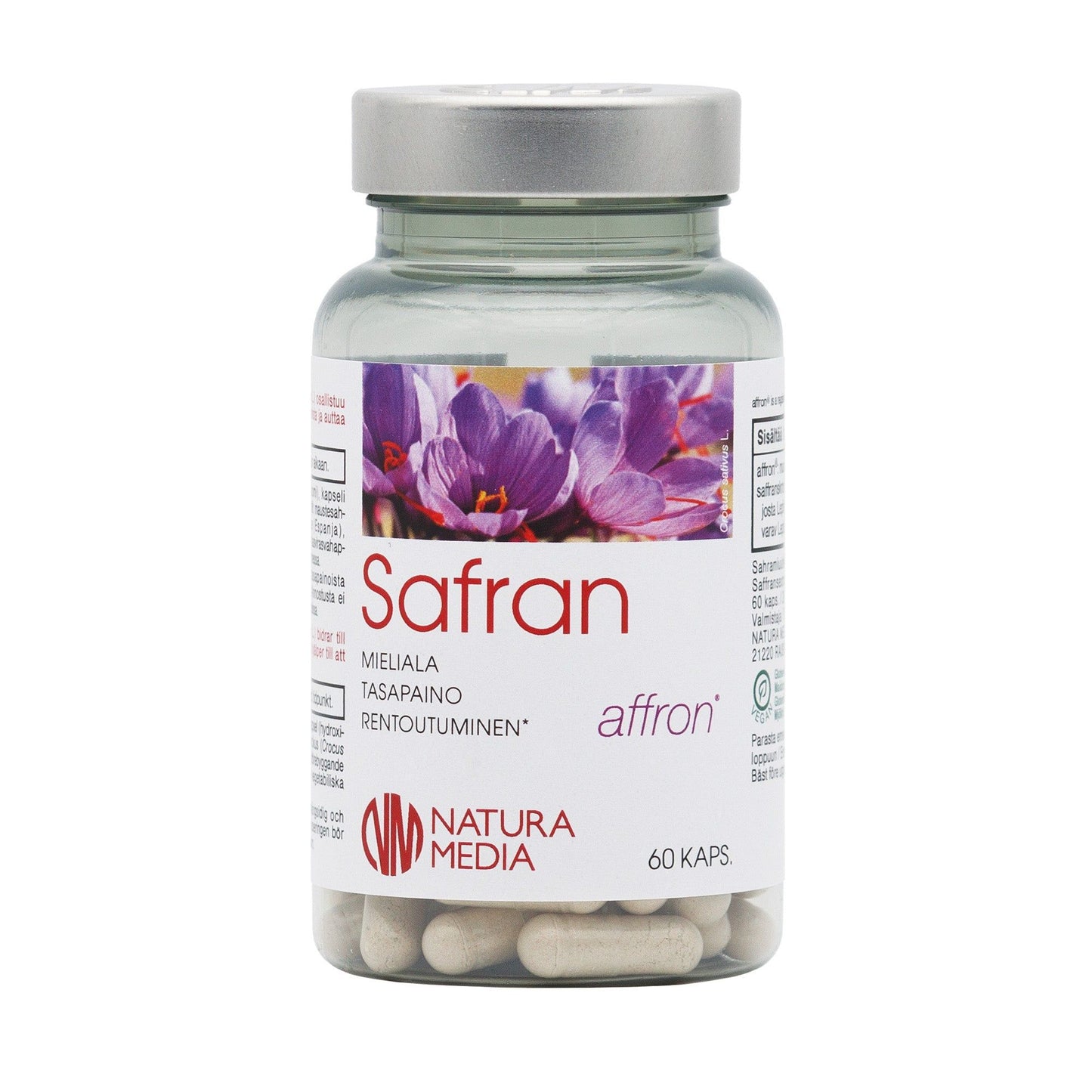 A clear cylindrical plastic jar with a glossy finish is shown, containing white capsules. The label reads “Safran,” features purple saffron flowers, and includes the text “Produced by Natura Media, 60 capsules.” The label uses simple sans-serif font styles. The product sits against a plain white background with no people or hands visible.