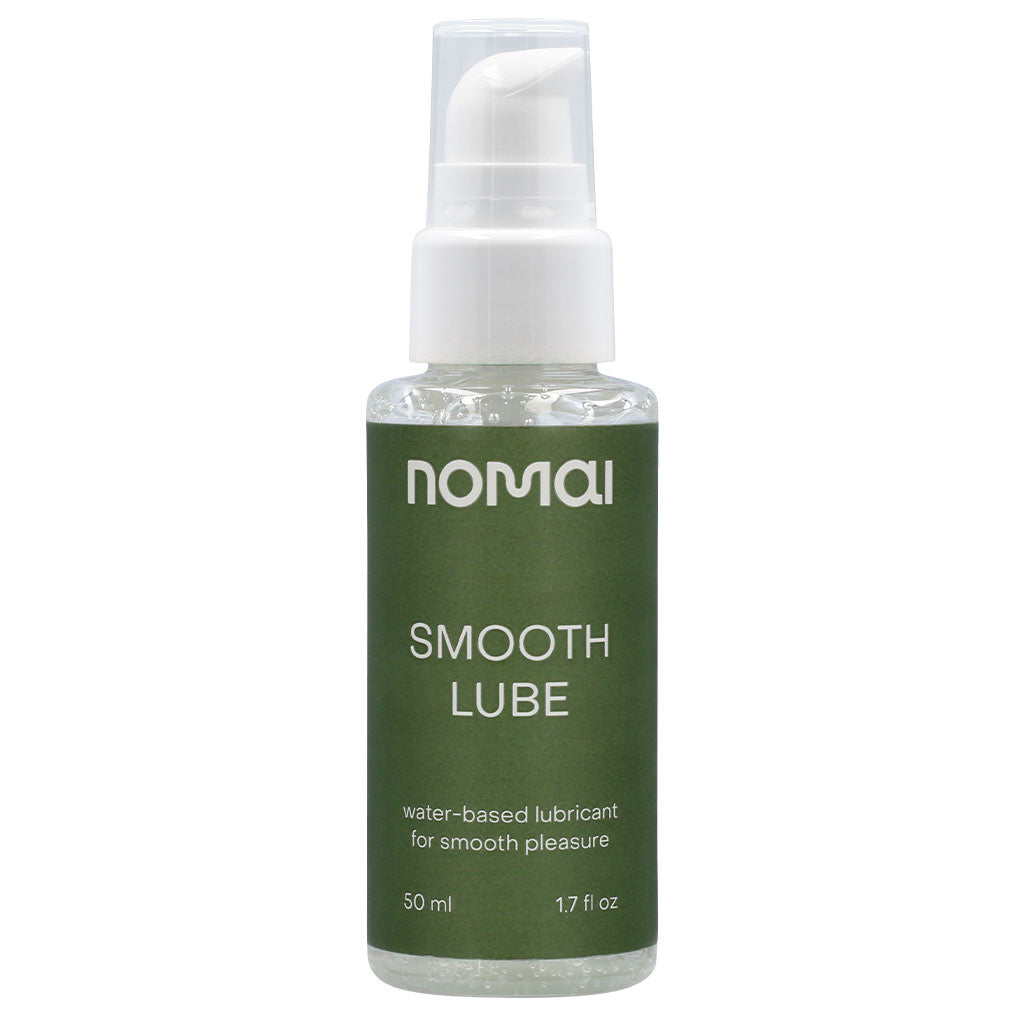 Nomai Vesipohjainen Liukuvoide; kirkas muovipullo Nomai Smooth Lube -liukuvoidetta vihreällä etiketillä ja valkoisella pumppukorkilla; pullo on sylinterinmuotoinen ja kiiltäväpintainen; etiketissä yksinkertaista valkoista ja tummanvihreää groteskitekstiä, mainitaan tuotenimi, tyyppi, tilavuus (50 ml, 1,7 fl oz) ja lisäkuvaus; ei ihmisiä tai käsiä näkyvissä; tausta valkoinen tai vaalean neutraali, kuvakulma edestä studiotyyliin.