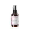 A brown spray bottle labeled puhdas+ Beauty Rose Water features a pink and white label with a floral design, containing 100 ml of hydrating mist. The cylindrical bottle is plastic with a matte finish and has a black spray nozzle. The label displays sans-serif text, showing product name and volume. No people or hands are visible. Product is photographed against a plain white background in front view.