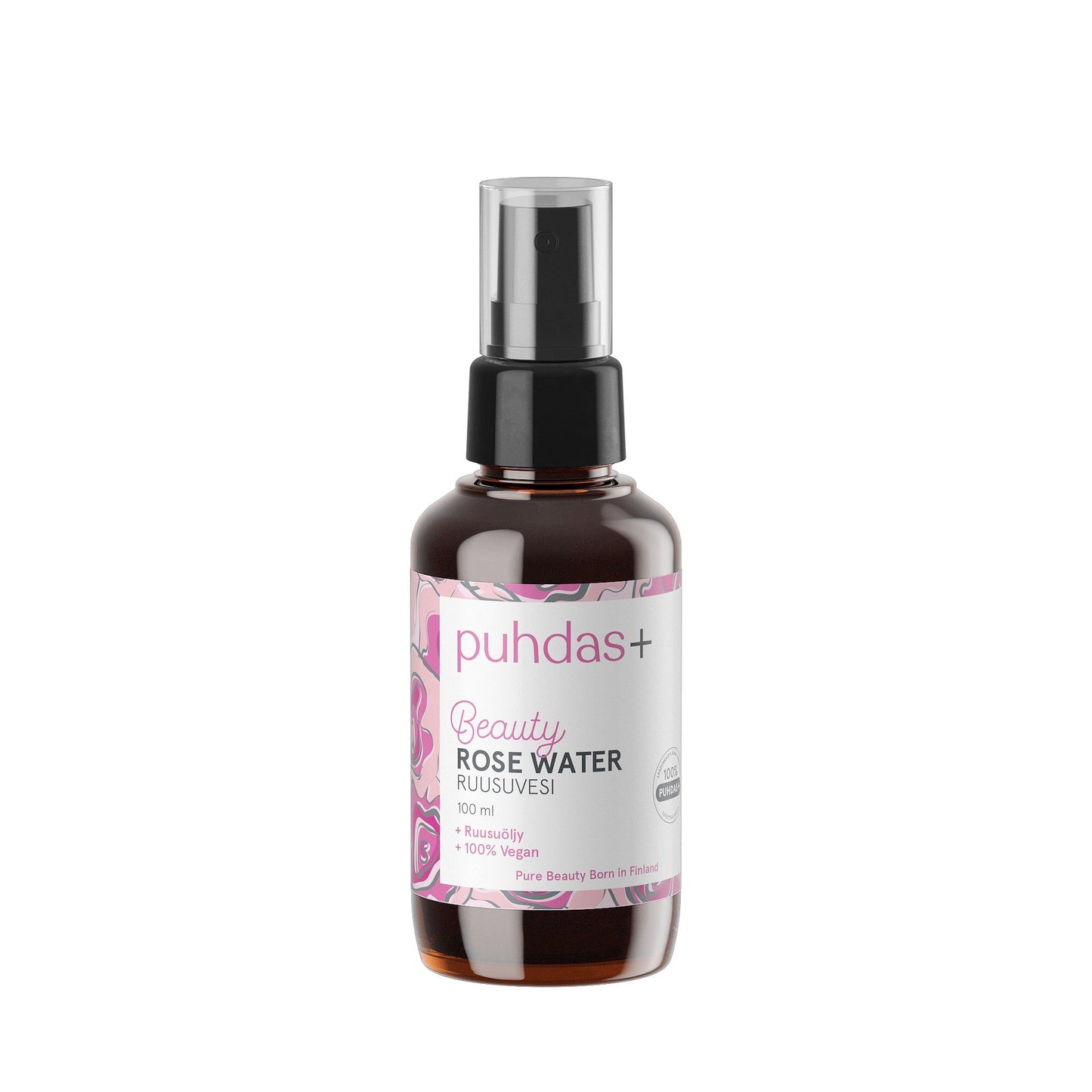 A brown spray bottle labeled puhdas+ Beauty Rose Water features a pink and white label with a floral design, containing 100 ml of hydrating mist. The cylindrical bottle is plastic with a matte finish and has a black spray nozzle. The label displays sans-serif text, showing product name and volume. No people or hands are visible. Product is photographed against a plain white background in front view.