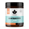 A jar of Puhdistamo Elektrolyytti-jauhe, a tropical-flavored electrolyte powder, with a vibrant white, orange, and teal label displaying product details in Finnish and highlighting its refreshing electrolytes. The container is cylindrical plastic with a glossy finish and screw-on lid. Bold sans-serif fonts are used on the label. The background is plain white and there are no people or objects in the shot.