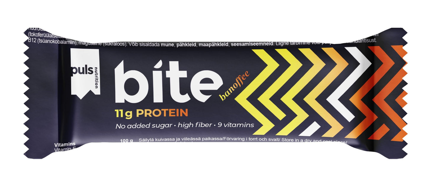 Puls BITE Banoffee; käärittynä proteiinipatukka tekstillä "bite banoffee", 11 g proteiinia, ilman lisättyä sokeria, runsaskuituinen ja sisältää 9 vitamiinia; pakkaus suorakulmainen mattapinnalla; suunnittelussa keltaisia, oransseja ja valkoisia vinoraitoja tummalla pohjalla; lihavoitua sans-serif-tekstiä sekä isoin että pienin kirjaimin etiketissä; tuote yksin neutraalilla pinnalla, tausta tumma ja kuvioimaton; ei ihmisiä tai käsiä näkyvissä.