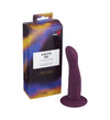 A purple silicone dildo with a suction base is displayed standing next to its vibrant packaging labeled Excite Me Classic Dildo by RFSU. The dildo has a smooth, matte finish and cylindrical shape with a slight taper at the tip. The box features bold, colorful graphics and clear sans-serif typography for the product name. Both items are set against a plain white background in a straightforward product shot, with no people or hands visible.