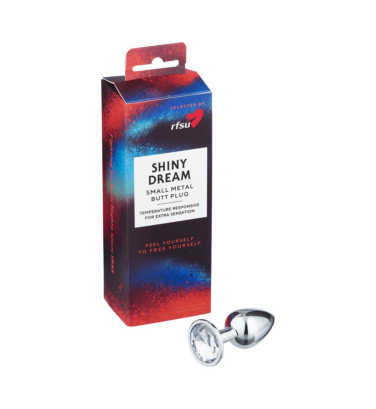 RFSU Shiny Dream Anaalitappi; pieni kiiltävä metallinen anaalitappi jalokivimäisellä kannalla värikkään pakkauksen vieressä, jossa teksti "SHINY DREAM Small Metal Butt Plug by RFSU"; tuote hopeanvärinen heijastavalla pinnalla, kyyneleenmuotoinen ja kirkas kulmikas jalokivi kannassa; pakkauksessa puna-sinisiä grafiikkakorostuksia; laatikko pystyssä vaalealla taustalla.