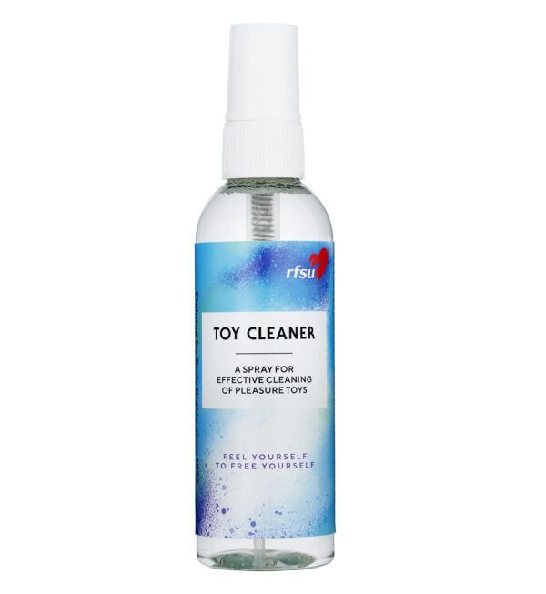 A clear plastic spray bottle labeled Toy Cleaner with a blue and white design, constructed of transparent plastic. The cylindrical bottle has a matte finish and a white spray nozzle. Notable sans-serif typography is used on the label, which includes the RFSU logo and text: Feel yourself to free yourself. Product is shown against a plain, neutral background. No people or hands are visible in the image.