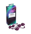 A boxed vaginal trainer set labeled “Kegel Balls” is displayed alongside three purple kegel weights of different sizes, all made from smooth, matte body-safe material. Boxes have bold sans-serif typography. Packaging and weights are shown on a plain white background with even lighting. No people or hands are visible in the shot.