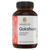 A brown plastic bottle labeled Gokshura+ by Saharogya, containing 60 vegan capsules. The cylindrical bottle has a screw cap and a glossy surface. The label displays a decorative line pattern, printed text in Finnish and Swedish, and a round gold-and-white seal stating 100% pure extract and vegan formula. No people or hands are visible in the product-only shot with a plain background.