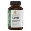 A brown plastic bottle labeled SAHAROGYA Karela with decorative patterns on a matte label. The cylindrical bottle has a black screw cap. Typography is bold sans-serif for the product name and supporting information. Label shows blood sugar support, 60 vegan capsules (34g), Finnish and Swedish text. Neutral solid background, studio shot, no people or hands present.