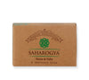 A rectangular, matte-finished brown box of Saharogya premium handcrafted wellness soap, labeled Neem & Tulsi. The packaging displays green ornamental and ayurvedic motif graphics with legible product text in a clean sans serif typeface. The box is photographed against a plain light background, with no people or hands visible.