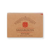A rectangular brown box labeled “SAHAROGYA Red Sandal A Wellness Soap” is visible. The packaging is matte, features a decorative red design, and includes the words “Premium Handcrafted” above the main logo in serif font. No people or hands are present, and the background is plain. Shot type is front-facing product-only. A rectangular brown box labeled SAHAROGYA Red Sandal A Wellness Soap features a decorative red design and the text Premium Handcrafted above the logo, highlighting its natural wellness