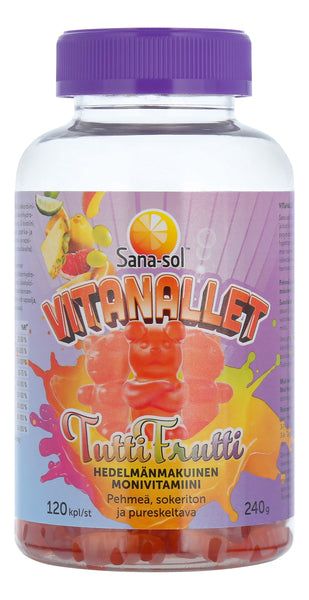 Sana-sol Vitanallet Tuttifrutti; pullo Sana-sol Vitanallet Tutti Frutti -monivitamiinipurukumeja, etiketissä värikkäitä hedelmäkuvia ja suuri oranssi karhupurukumin kuvitus, teksti suomeksi; pullo kirkasta muovia violetilla, uritetulla muovikorkilla; etiketissä lihavoitua groteskityyppografiaa sekä luvut ”120” ja ”240g”; ei ihmisiä tai käsiä näkyvissä; kuva edestä tasaisella taustalla.