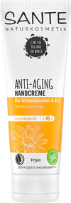 Sante Käsivoide Anti-Aging; tuubi anti-aging-käsivoidetta päivänkakkaralla ja Q10:llä, merkitty vegaaniseksi ja luomuksi, valko-oranssi design; tuubi on mattapintainen pyöristetyllä korkilla; saksankielistä groteskitekstiä etuetiketissä kuvaa hoitointensiteettiä ja nuorekkaan ihon hyötyjä; ei ihmisiä tai käsiä näkyvissä; tuote kuvattu yksivärisellä taustalla suoraan edestä.
