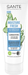 Sante Moisture Fresh 3 in 1 Kuorintavoide; tuubi 3-in-1-voidekuorintaa seisoo pystyssä mattapinnalla; valko-vihreä pakkaus esittää kuvia aaloe verasta ja avokadosta; etiketissä selkeää groteskikirjasinta, listaa vegaanisuuden, luomun ja sopivuuden kaikille ihotyypeille; ei ihmisiä tai käsiä näkyvissä; tausta vaalea ja pehmeästi valaistu.