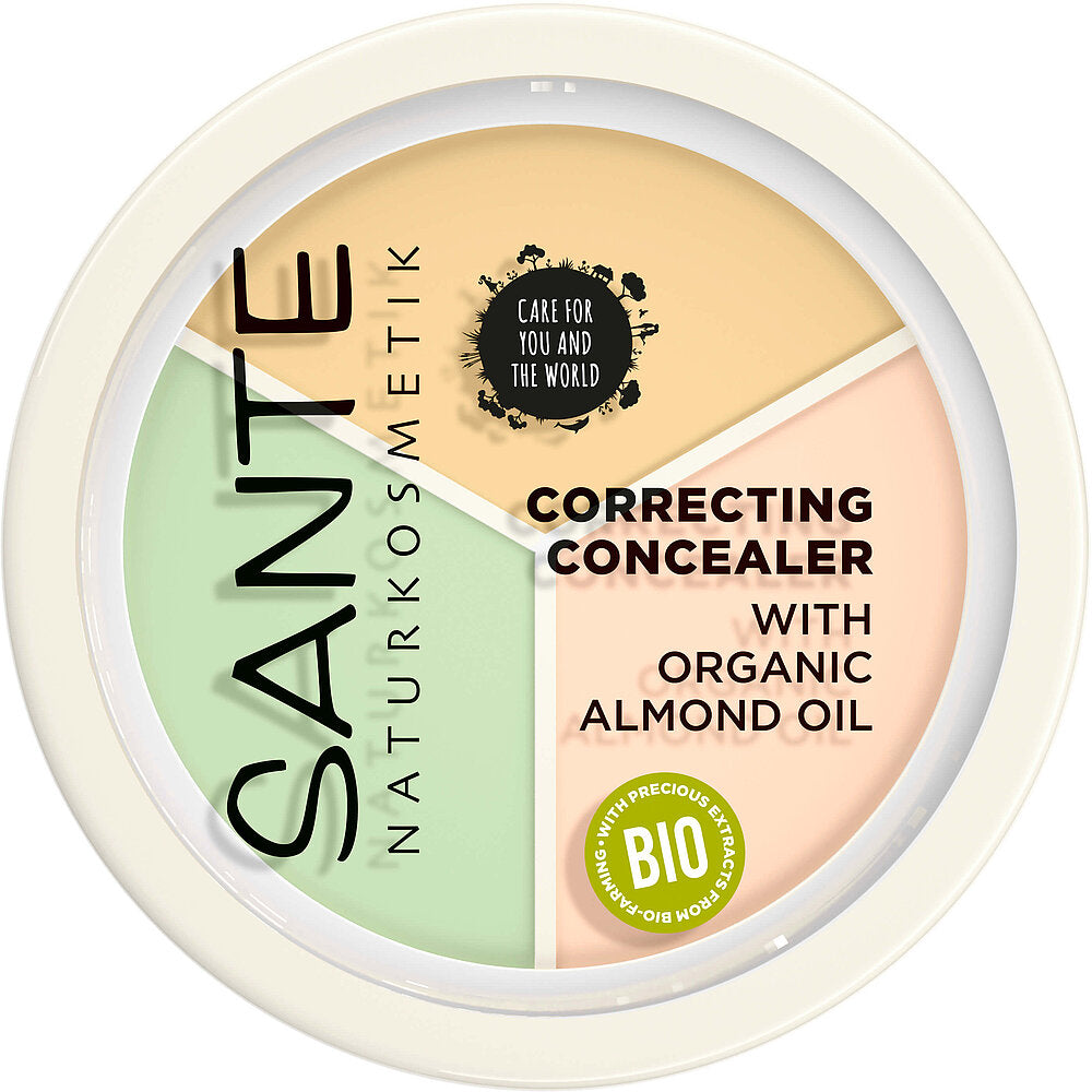 Sante Sävyä Korjaava Peitevoide: pyöreä Sante Naturkosmetik -korjaava peitevoiderasia luomumanteliöljyllä; voide on jaettu kolmeen osaan – vihreä, keltainen ja persikanvärinen; etiketissä teksti "BIO" ja "Care for you and the world" yksinkertaisella groteskikirjasimella; rasia on mattapintainen läpinäkyvällä kannella, josta tuote näkyy; ei ihmisiä tai käsiä näkyvissä, neutraali tausta.