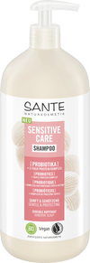Sante Sensitive Care Shampoo; pullo probioottishampoota, merkitty hellävaraiseksi, vegaaniseksi ja sopivaksi herkälle hiuspohjalle; beige muovipullo mattapinnalla, sylinterinmuotoinen runko pyöristetyin olkapäin, valkoinen pumppuannostelija; etiketissä vihreää, pinkkiä ja valkoista groteskitekstiä sekä kuvakkeita; tuote kuvattu pystyssä valkoisella taustalla.