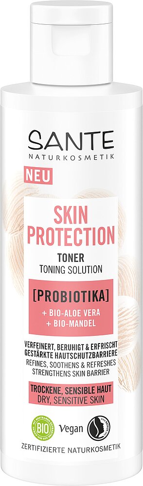 Sante Skin Protection Kasvovesi; valkoinen sylinterinmuotoinen pullo merkitty Sante Naturkosmetik Skin Protection Toner seisoo pystyssä; pinta mattapintainen, teksti painettu selkeällä groteskikirjasimella; etiketissä vegaani- ja luomusertifiointimerkinnät; pullossa mainitaan probiootti, luomu-aaloe vera ja luomu-manteli kuivalle tai herkälle iholle; kuvan tausta yksivärinen.