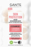 Sante Skin Protection Rauhoittava Kasvonaamio; pussi Sante Naturkosmetik Skin Protection -välitöntä rauhoittavaa kasvonaamiota, korostaa keramideja, rypäleensiemenöljyä ja luomu-sheavoita kuivalle, herkälle iholle; suorakulmainen mattapintainen pussi valkoisena ja vaimean vihreänä, musta-vihreää groteskitypografiaa; vegaanisertifiointilogo näkyvissä; pakkaus ilmoittaa naamion olevan rikastettu luomu-ainesosin; tausta yksivärinen, ei käsiä tai ihmisiä näkyvissä.