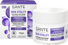 A box and jar of Sante Skin Vitality Smoothing Day Cream featuring purple accents, product details, and icons highlighting vegan and natural certification. The box is rectangular with a matte finish, white base, bold sans-serif typography, and clear logos. The cylindrical jar has a white cap and matching purple details. Both display concise label text. Set against a plain background in a product-focused shot. This nourishing formula is suitable for all skin types.