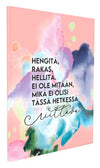 A pastel-colored book cover with Finnish text and abstract watercolor shapes in pink, blue, green, and yellow. The text reads: Hengitä, rakas, hellitä. Ei ole mitään, mikä ei olisi tässä hetkessä riittävä—a gentle reminder to pause and breathe. Cover is matte with no visible packaging. Typography is simple sans-serif in black. Product is rectangular and set against a plain background. No people or hands are visible in the image. Shot is straight-on front view showing full cover design.