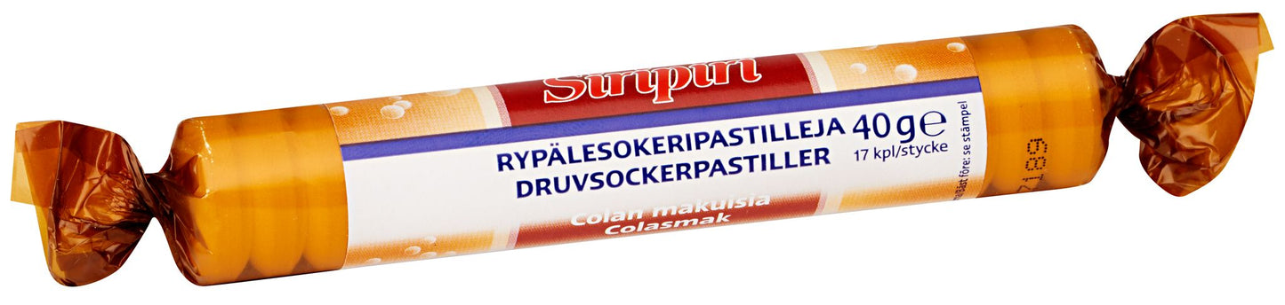A roll of Sirupin grape sugar pastilles in orange and white cylindrical packaging, matte finish, with bold sans-serif typography. Label text in Finnish and Swedish includes Cola flavor and 40g. No visible people or hands. Neutral background, product centered in the frame.